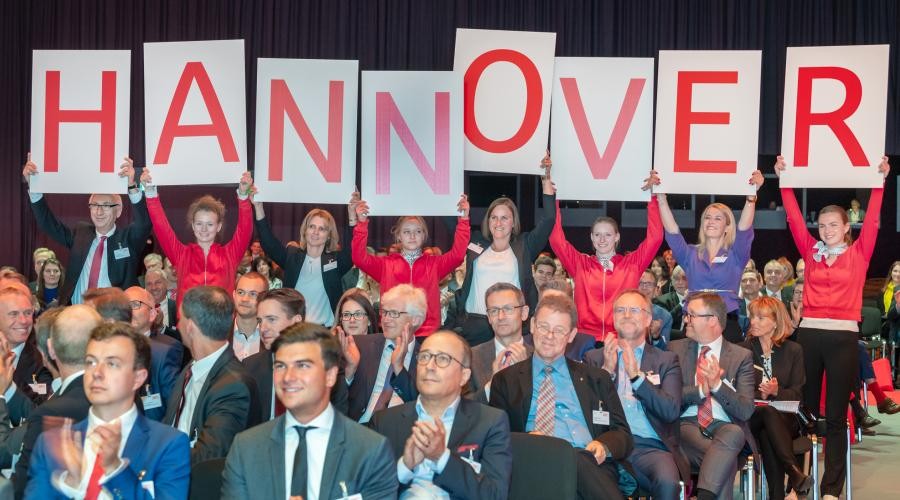 Mitarbeitende der Sparkassen halten ein Schild mit der Aufschrift Hannover hoch. - Quelle: DSGV